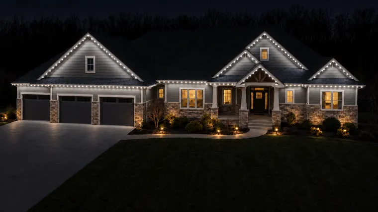 A home at night with its roofline lit cool white