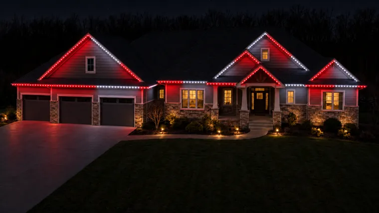 A home at night with permanent roofline lighting set to red wings