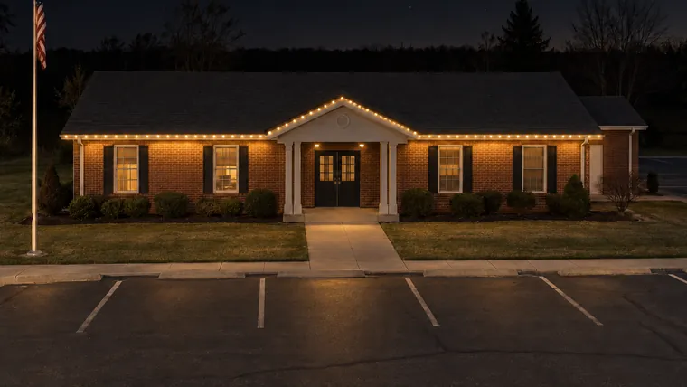 A township hall at night with permanent roofline lighting set to warm white